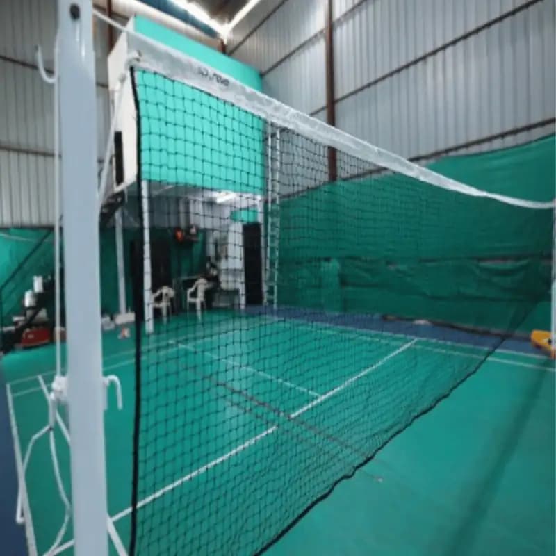 Side view of Garware Sportiva Badminton Net installed across a badminton court in an indoor hall